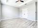 Primary bedroom with wood-look floors, double-door closet, and access to bathroom at 319 Ravenshill Way, Deland, FL 32724