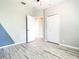 Bedroom with wood-look flooring and access to another room at 319 Ravenshill Way, Deland, FL 32724