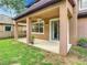 Covered patio with ceiling fan and access to yard at 319 Ravenshill Way, Deland, FL 32724