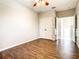 Spacious bedroom with wood-look floors, double doors to a closet, and access to a hallway at 319 Ravenshill Way, Deland, FL 32724