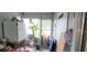 Small laundry area with refrigerator, potted plants, and folding chairs at 9 Villa Villar Ct, Deland, FL 32724
