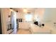 Modern kitchen with white cabinets, quartz countertops, and stainless steel appliances at 9 Villa Villar Ct, Deland, FL 32724