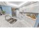 Modern kitchen with white cabinets and granite counters at 4575 S Atlantic Ave # 6307, Ponce Inlet, FL 32127