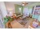 Bright sunroom features wicker furniture & tiled floor at 4575 S Atlantic Ave # 6307, Ponce Inlet, FL 32127