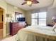 Bedroom with large window, dresser, and TV; shows access to bathroom at 2403 S Atlantic Ave # 409, Daytona Beach Shores, FL 32118