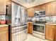 Stainless steel appliances and wood cabinets in a condo kitchen at 2403 S Atlantic Ave # 409, Daytona Beach Shores, FL 32118