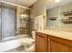 Clean bathroom with a walk-in shower, wood vanity, and neutral tile at 2403 S Atlantic Ave # 409, Daytona Beach Shores, FL 32118