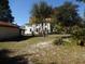Large backyard with mature trees and outbuildings at 207 E 2Nd Ave, Pierson, FL 32180