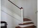 Classic staircase with white railing and hardwood steps at 207 E 2Nd Ave, Pierson, FL 32180