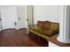 Hallway with hardwood floors and antique couch at 207 E 2Nd Ave, Pierson, FL 32180
