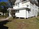 Two-story white house with a wrap-around porch and mature trees at 207 E 2Nd Ave, Pierson, FL 32180