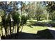 Landscaped yard with mature trees and a sidewalk at 207 E 2Nd Ave, Pierson, FL 32180