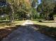 Long driveway leading to home with mature trees at 207 E 2Nd Ave, Pierson, FL 32180
