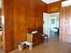 Quaint dining room features wood walls and hardwood floors at 207 E 2Nd Ave, Pierson, FL 32180