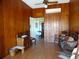 Sitting room with wood paneled walls and antique furniture at 207 E 2Nd Ave, Pierson, FL 32180