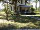 Two-story house exterior with porch and large trees at 207 E 2Nd Ave, Pierson, FL 32180