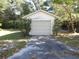 Detached garage with a large door and paved driveway at 207 E 2Nd Ave, Pierson, FL 32180