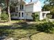 Two-story white house with wrap around porch at 207 E 2Nd Ave, Pierson, FL 32180