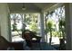 Relaxing front porch with wicker chairs and view of yard at 207 E 2Nd Ave, Pierson, FL 32180