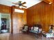 Sitting room with wood paneled walls and antique furniture at 207 E 2Nd Ave, Pierson, FL 32180