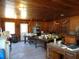 Large common area with wood walls, multiple tables, and vintage furniture at 207 E 2Nd Ave, Pierson, FL 32180