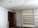 Storage room with wooden shelving and curio cabinet at 207 E 2Nd Ave, Pierson, FL 32180
