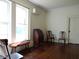 Bright living room with hardwood floors, large windows, and antique furniture at 207 E 2Nd Ave, Pierson, FL 32180