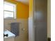 Small bathroom with shower, yellow walls and tile at 207 E 2Nd Ave, Pierson, FL 32180