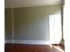 Simple bedroom with hardwood floors and white door at 207 E 2Nd Ave, Pierson, FL 32180