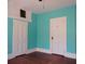 Spacious bedroom featuring teal walls, hardwood floors, and two closets at 207 E 2Nd Ave, Pierson, FL 32180