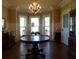 Bright dining room with bay window, chandelier, and hardwood floors at 207 E 2Nd Ave, Pierson, FL 32180