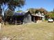 Rustic outbuilding with metal roof and wooden structure at 207 E 2Nd Ave, Pierson, FL 32180