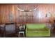 Living room with green couch and vintage wooden chair at 207 E 2Nd Ave, Pierson, FL 32180
