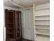 Storage room with wooden shelving and curio cabinet at 207 E 2Nd Ave, Pierson, FL 32180