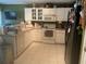 L-shaped kitchen with white cabinets and standard appliances at 6131 Sabal Point Cir, Port Orange, FL 32128