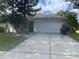 Single-story home with attached garage and well-maintained lawn at 6131 Sabal Point Cir, Port Orange, FL 32128