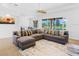 Bright living room featuring sectional sofa and pool view at 5994 Seminole Woods Dr, Port Orange, FL 32127