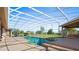 Inviting screened pool area with lush landscaping at 5994 Seminole Woods Dr, Port Orange, FL 32127