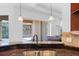 Kitchen with double sink, granite counters and view of pool at 5994 Seminole Woods Dr, Port Orange, FL 32127