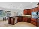 Spacious kitchen with dark wood cabinets and granite counters at 5994 Seminole Woods Dr, Port Orange, FL 32127