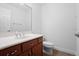 Clean bathroom with wood vanity and a large mirror at 5994 Seminole Woods Dr, Port Orange, FL 32127