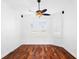 Bright bedroom with hardwood floors and ceiling fan at 5994 Seminole Woods Dr, Port Orange, FL 32127