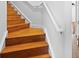 Elegant wooden staircase with white railings at 5994 Seminole Woods Dr, Port Orange, FL 32127