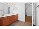 Double vanity bathroom with wood cabinets and tile flooring at 5994 Seminole Woods Dr, Port Orange, FL 32127