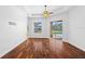 Bright bedroom with hardwood floors and sliding doors to a pool view at 5994 Seminole Woods Dr, Port Orange, FL 32127