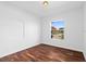 Spacious bedroom with hardwood floors and a large window at 5994 Seminole Woods Dr, Port Orange, FL 32127