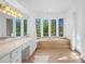 Spacious bathroom with a garden tub, double vanity, and large mirror at 5994 Seminole Woods Dr, Port Orange, FL 32127