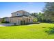 Two-story house with three car garage and manicured lawn at 5994 Seminole Woods Dr, Port Orange, FL 32127