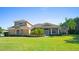 Two-story home with stone accents and manicured lawn at 5994 Seminole Woods Dr, Port Orange, FL 32127