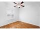 Bedroom with hardwood floors, ceiling fan, and plantation shutters at 5994 Seminole Woods Dr, Port Orange, FL 32127